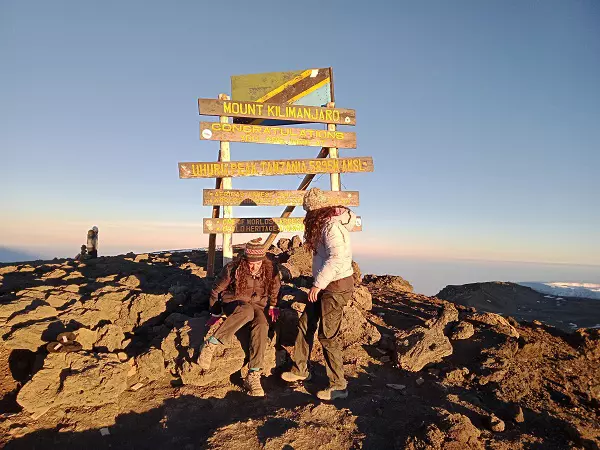 Trekkers celebrating after summiting during the 6-day Machame Route Kilimanjaro Climbing tour